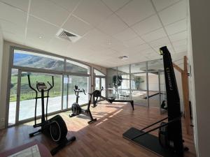 a gym with tread machines and a large window at Duplex 8 couchages, au pied des pistes de la Mongie in La Mongie