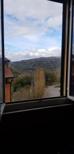 a window with a view of a countryside from a house at Monstera room Vicino al centro in Perugia