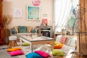 a living room with colorful pillows on the floor at Hôtel Le Castellan in Istres