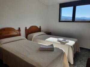 Ένα ή περισσότερα κρεβάτια σε δωμάτιο στο Hostal Apolo XI
