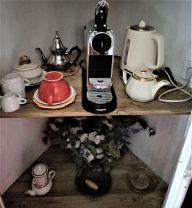 a shelf with a coffee maker and a tea kettle at Suite Provençale in Saignon