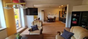 a living room with a couch and a dining room at Landhaus Wachendorf in Bruchhausen-Vilsen