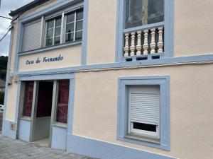 a blue and white building with a window at Casa de Fernando in Tríacastela
