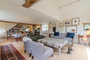 a living room with a couch and a table at Locks Cottage in Cheltenham