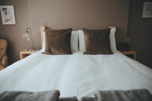 a large white bed with two pillows on it at The Canal in Whatstandwell