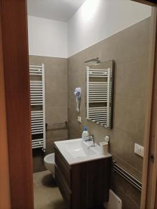 a bathroom with a sink and a toilet at Primae Noctis Rooms in Roccascalegna +11 photos