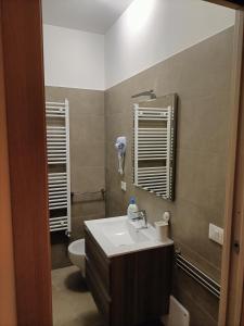 a bathroom with a sink and a toilet at Primae Noctis Rooms in Apartments in Roccascalegna