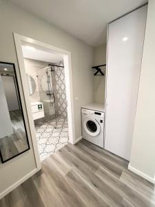 a laundry room with a washer and dryer at Dona I Apartments at Botanical Garden in Funchal