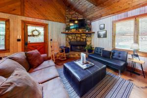 a living room with a couch and a fireplace at Toccoa River Retreat in Blue Ridge