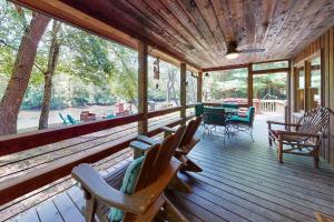 a screened in porch with chairs and a table at Toccoa River Retreat in Blue Ridge
