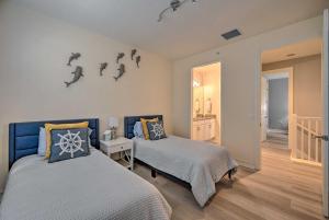 a bedroom with two beds and a bathroom at Lely Resort Condo about 10 Mi to Naples Beach! in Lely Resort +31 photos
