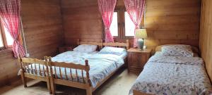 a bedroom with two beds in a log cabin at Vikendica Vlahović in Kolašin