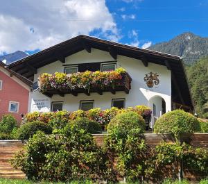 a house with flower boxes on the side of it at Ferienwohnung Kobler in Landeck