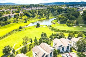 an aerial view of a house with a golf course at Walk to Strip! Cozy Branson Condo w/ Pool in Branson