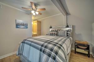 a bedroom with a bed with a ceiling fan at Beachfront Condo with Unobstructed Ocean Views! in Oak Island