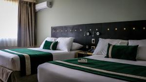 Posteľ alebo postele v izbe v ubytovaní Ecohotel Talca