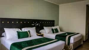 Posteľ alebo postele v izbe v ubytovaní Ecohotel Talca