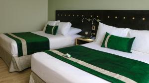 Posteľ alebo postele v izbe v ubytovaní Ecohotel Talca