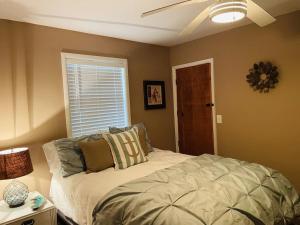 a bedroom with a bed and a ceiling fan at Comfy Beach House on Vero Beach in Vero Beach