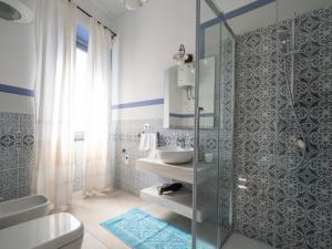 a bathroom with a glass shower and a sink at Affittacamere Solki in SantʼAntìoco