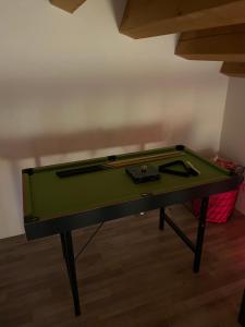 a green pool table sitting in a room at Casa vacanze fra gli ulivi in Morano Madonnuccia