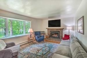 a living room with a couch and a fireplace at Stockbridge Home Walk to Town Beach! in Stockbridge
