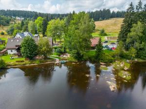 an aerial view of a lake in a town at Penzion Koucký in Bedřichov