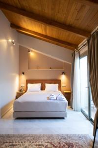 a bedroom with a bed and a large window at Patras Casale in Patra