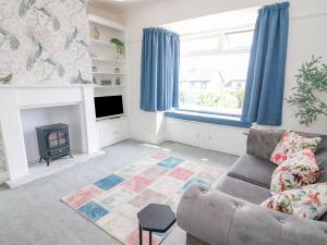 a living room with a couch and a fireplace at 148 Fairfield Road in Morecambe