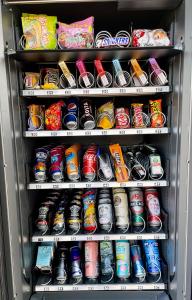 a refrigerator filled with lots of soda cans at Hotel Schwarzes Ross in Ganderkesee