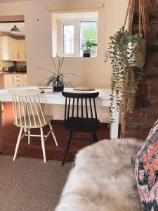 a living room with a table and two chairs at Boutique country hideaway ‘Jacks Cottage’ in Diddlebury