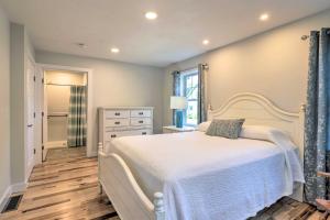 a bedroom with a white bed and a dresser at Sun-Dappled Retreat - Walk to Wickaboag Lake! in West Brookfield