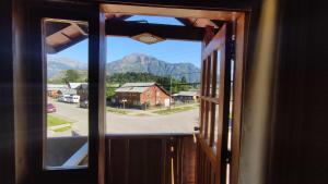 an open window with a view of a mountain at Hostería Futaleufu in Futaleufú