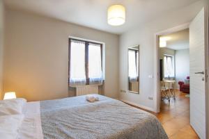 a bedroom with a large bed and two windows at [VERONA - CASTEL SAN PIETRO] in Verona