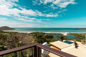 a view of the ocean from the balcony of a house at Pousada Descanso do Rei - Vista Para o Mar & Melhor Localização da Praia do Rosa in Praia do Rosa