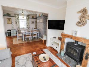a living room with a fireplace and a table at 7 Marine Drive in Hartlepool