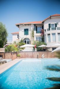 a swimming pool in front of a house at La Garoupe-Gardiole in Antibes