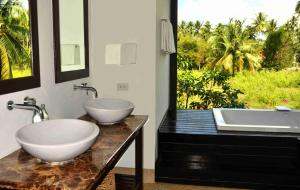 a bathroom with two sinks and a large window at Baan Chom Tawan Villa in Lipa Noi
