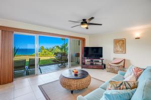 a living room with a couch and a table at Pali Ke Kua 111 in Princeville