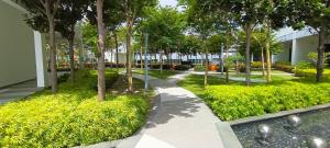 a walkway in a park with trees and grass at Cyberjaya cybersqure peace home in Cyberjaya
