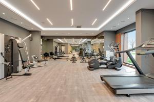 a gym with treadmills and cardio equipment in a room at Seaside Apartments Baltica Tower with Gym, Sauna & Parking in Gdańsk