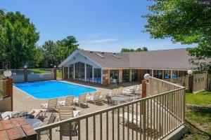 a house with a swimming pool and chairs next to a house at Branson Krehbiel Condo 2Bd 2Bath in Branson