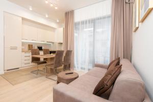 a living room with a couch and a table at Apartment Odysseus in Tivat