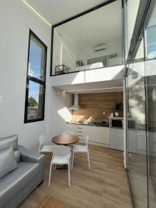 een keuken en een woonkamer met een tafel en een bank bij Casa rural - bungalows Spa & Relax in La Felipa