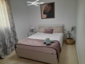 a bedroom with a bed with a stuffed animal on it at Arode Apartamento in Los Abrigos