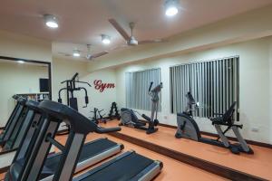 a gym with several tread machines in a room at Sonesta Inns Beach Resort - Candolim Beach in Candolim