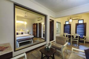 a bedroom with a bed and a living room at Sonesta Inns Beach Resort - Candolim Beach in Candolim