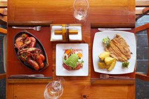 a table with three plates of food on it at El Molino Hotel y Restaurant in Lunahuaná