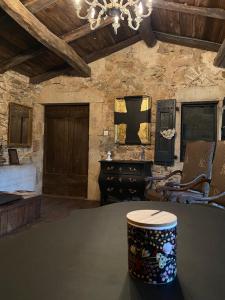 a room with a table and chairs and a chandelier at Studio avec terrasse dans mas historique cevenol in Saint-Paul-la-Coste