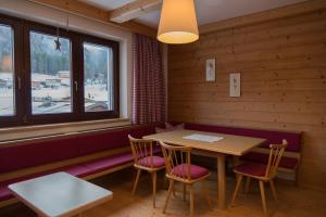 a dining room with a table and chairs and a window at Haus Barbara in Waidring